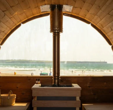 Warm seaside sauna with ocean view, offering a relaxing escape by the beach with natural wood interiors.